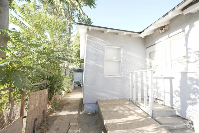 a living room with furniture a flat screen tv and a floor to ceiling window