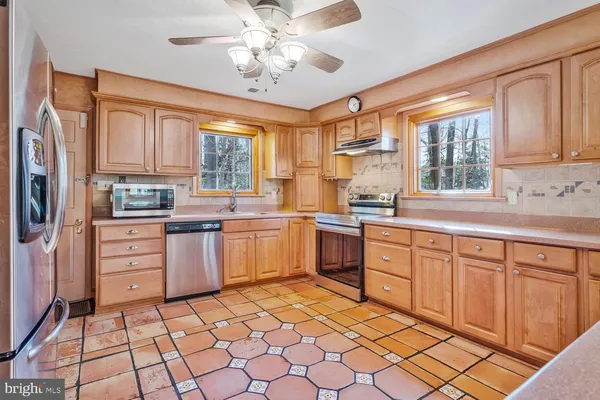 a kitchen with a stove a sink and a refrigerator