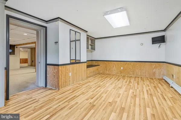 a view of a hallway with wooden floor