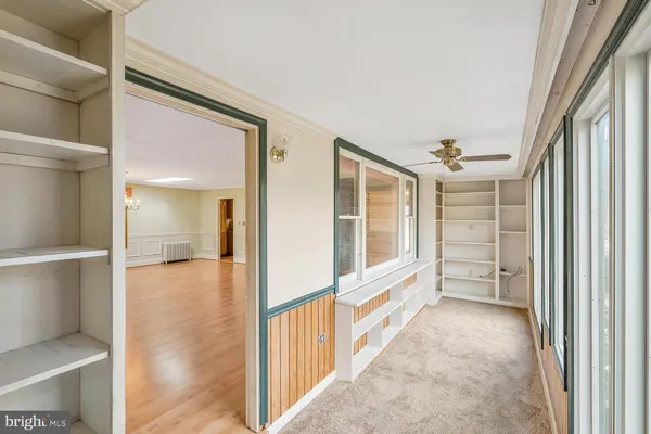 a view of an entryway with wooden floor and windows