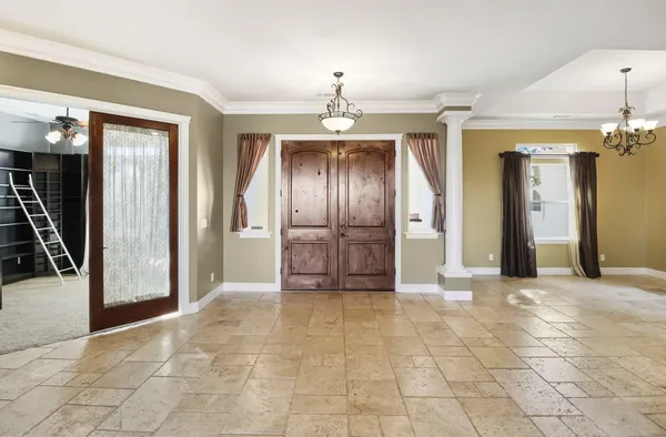 a view of an empty room with a fireplace and a window