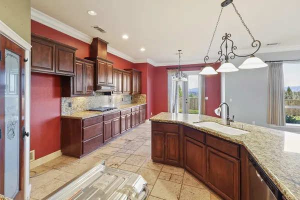 a view of a kitchen with granite countertop cabinets and wooden floor