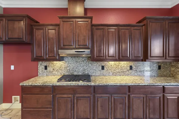 a kitchen with a stove a refrigerator and a sink