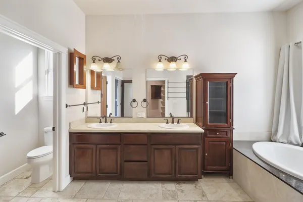a bathroom with a sink double vanity granite and a mirror