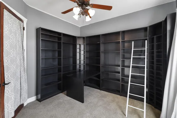 a hallway with cabinets and a window