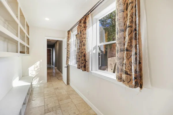 a view of a livingroom with a ceiling fan and window