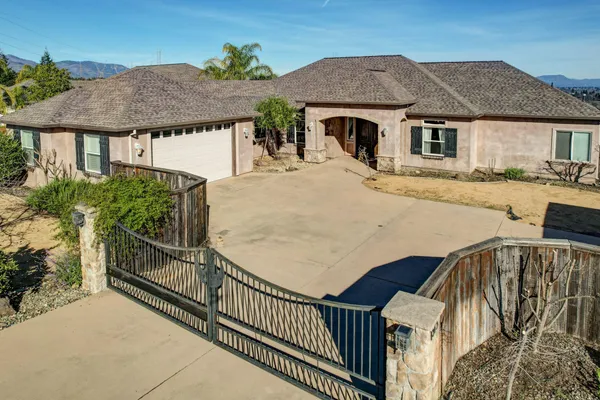 a view of a house with pool and wooden fence