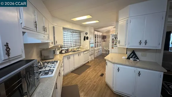 a bedroom with a bed a flat screen tv and dresser