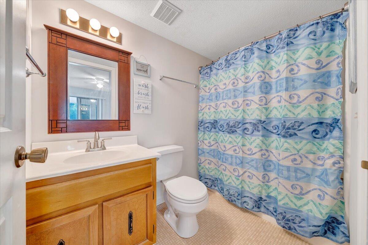 620 Monte Vista Road, Unit 602 Union Hall, VA 24176 - Photo 18 of 48 a bathroom with a granite countertop sink a toilet and a mirror