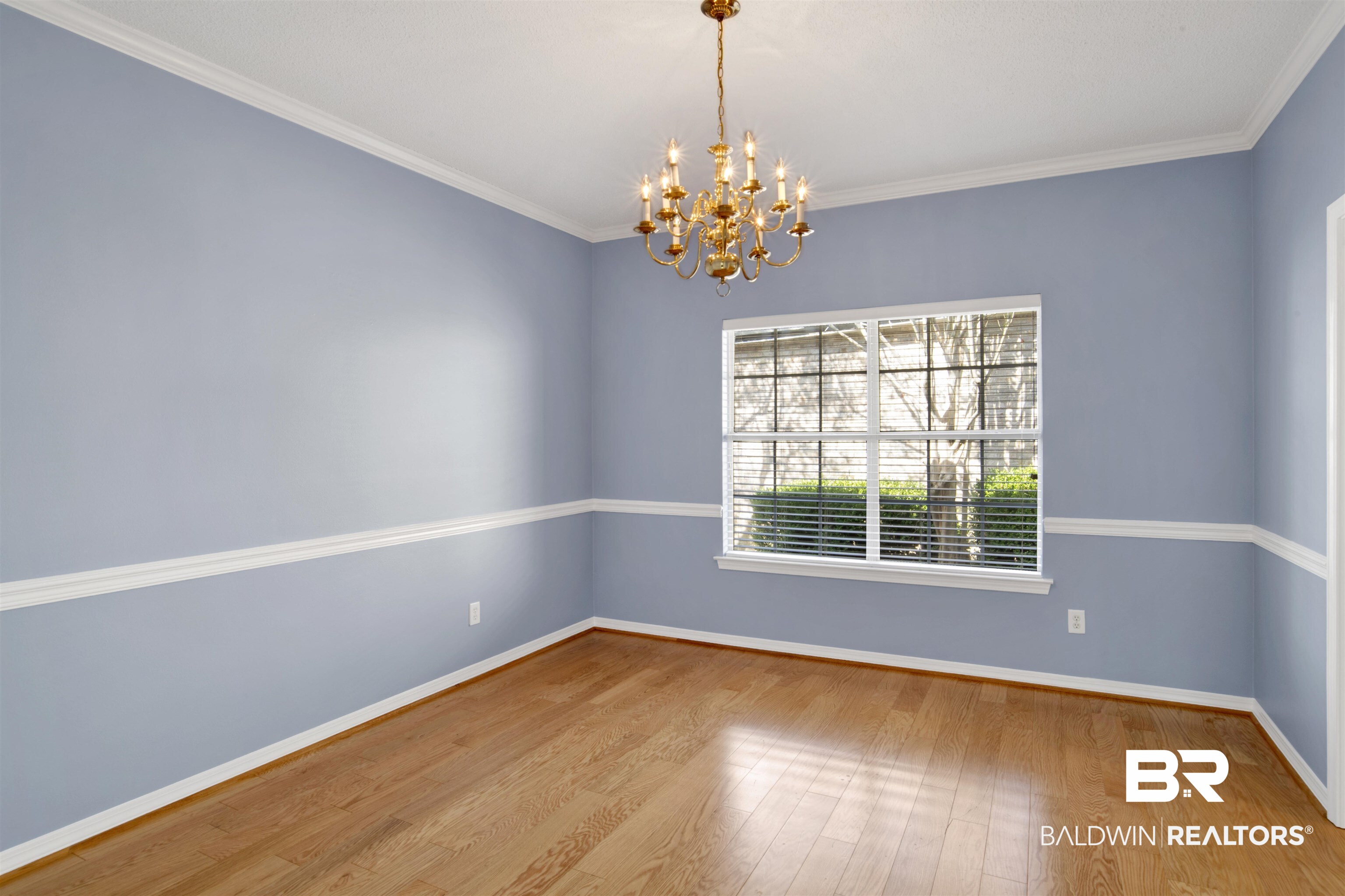 125 Woodruff Court Mobile, AL 36608 - Photo 9 of 27 Dining room with a notable chandelier, wood-type flooring, and ornamental molding