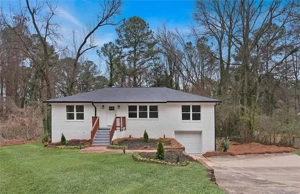 a backyard of a house with table and chairs