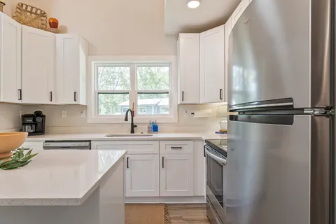 a kitchen with a table chairs stove and cabinets