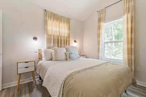 a bedroom with a bed and a mirror