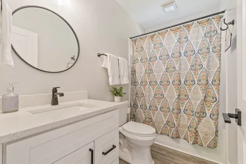 a bedroom with a bed and a mirror