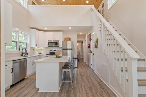 a kitchen with cabinets a sink and wooden floors