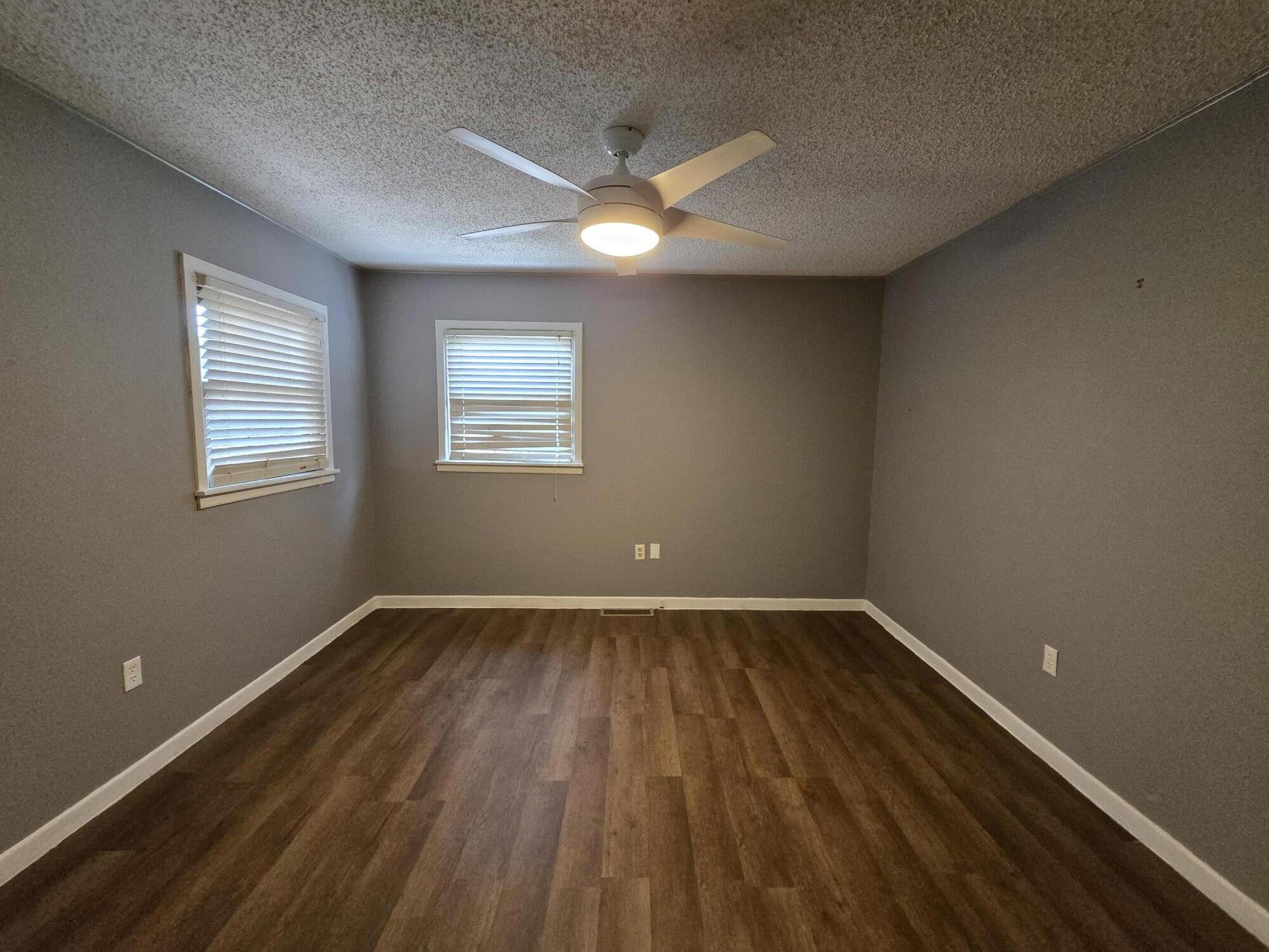 506 North 19th Street Lamesa, TX 79331 - Photo 16 of 29 a view of an empty room with wooden floor and a window