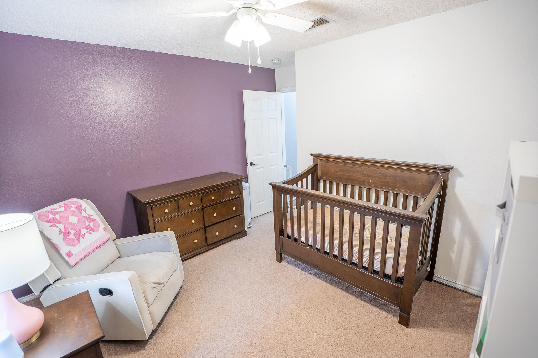 1609 78th Street Lubbock, TX 79423 - Photo 27 of 36 a bedroom with furniture and a baby crib