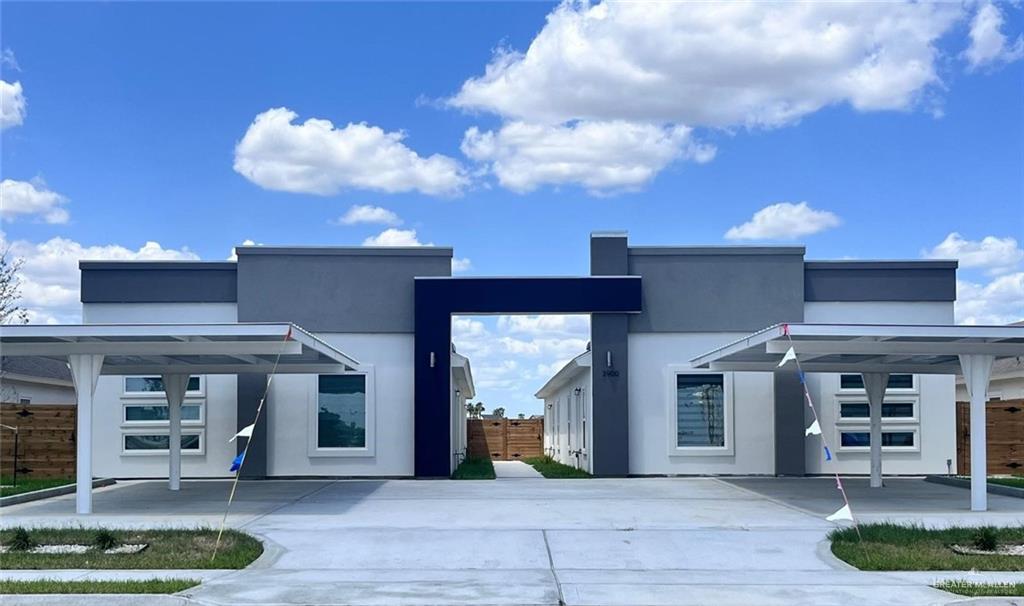 View of front facade with stucco siding and fence