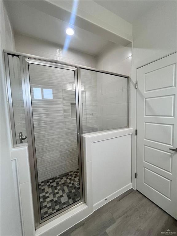 3904 Ventura Avenue, Unit 1 Edinburg, TX 78541 - Photo 4 of 12 Full bathroom featuring wood finished floors and a shower stall