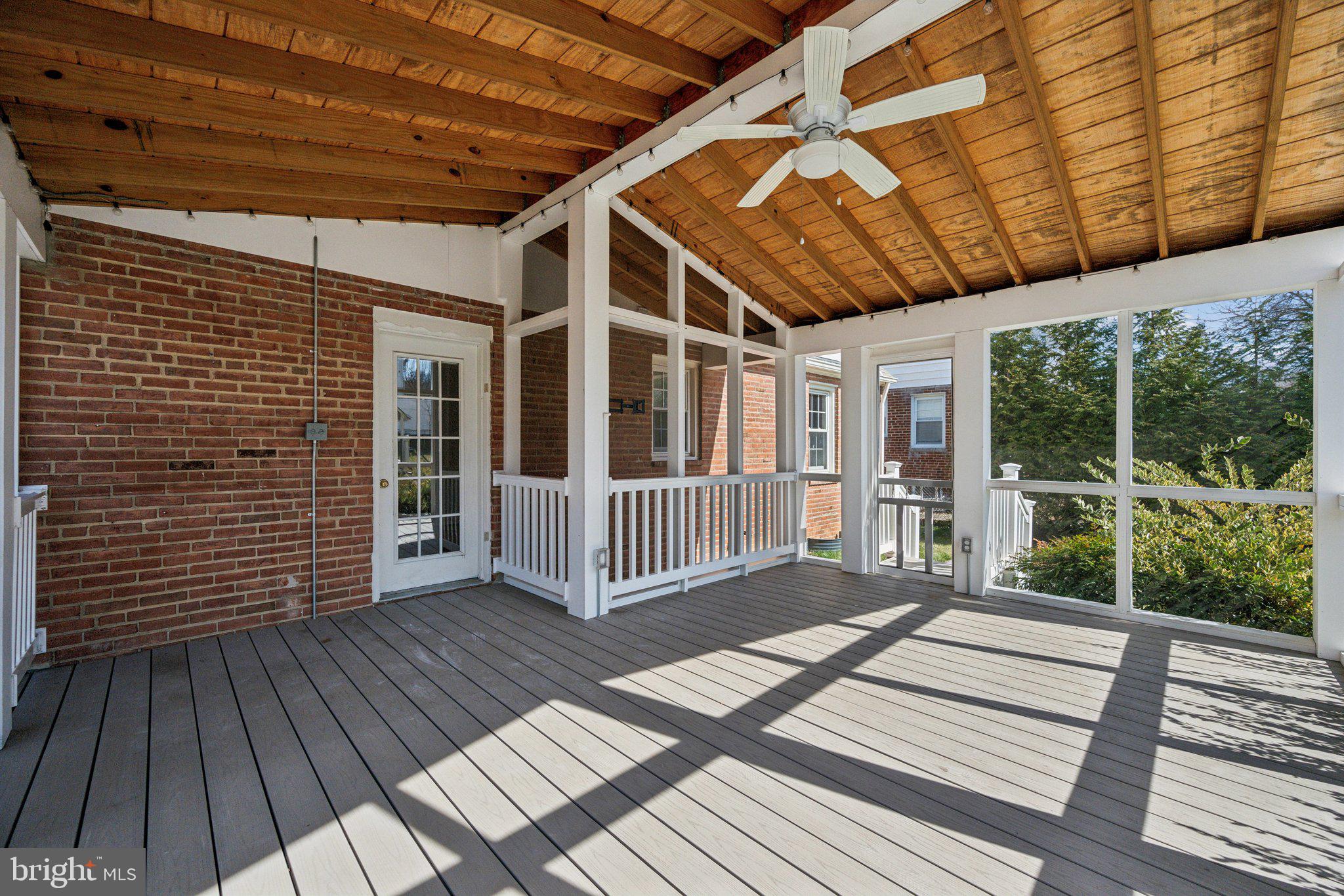 1720 Dublin Drive Silver Spring, MD 20902 - Photo 12 of 34 a porch with wooden floor in front of a house