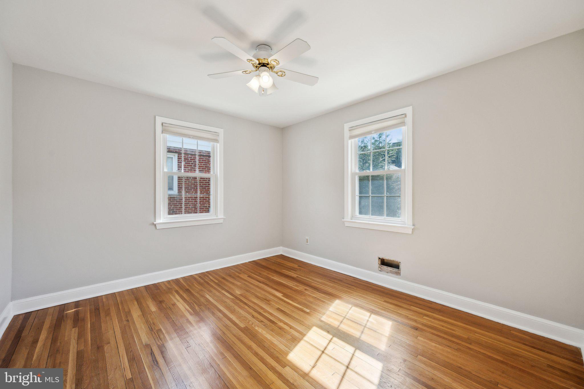1720 Dublin Drive Silver Spring, MD 20902 - Photo 15 of 34 a view of an empty room with wooden floor and a window