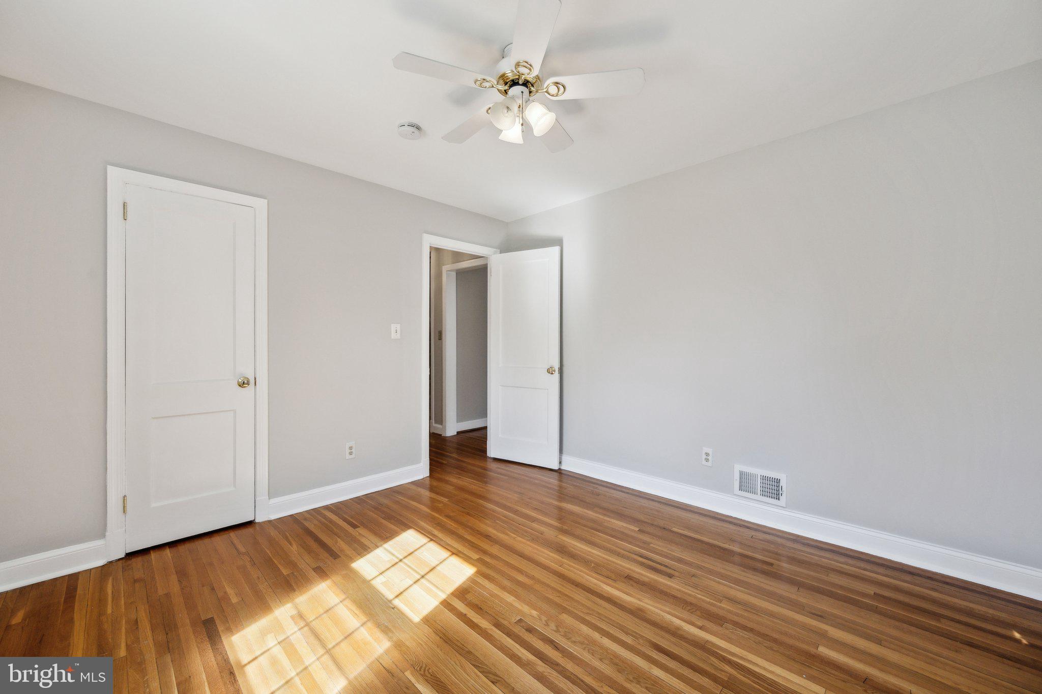 1720 Dublin Drive Silver Spring, MD 20902 - Photo 16 of 34 wooden floor in an empty room with a window