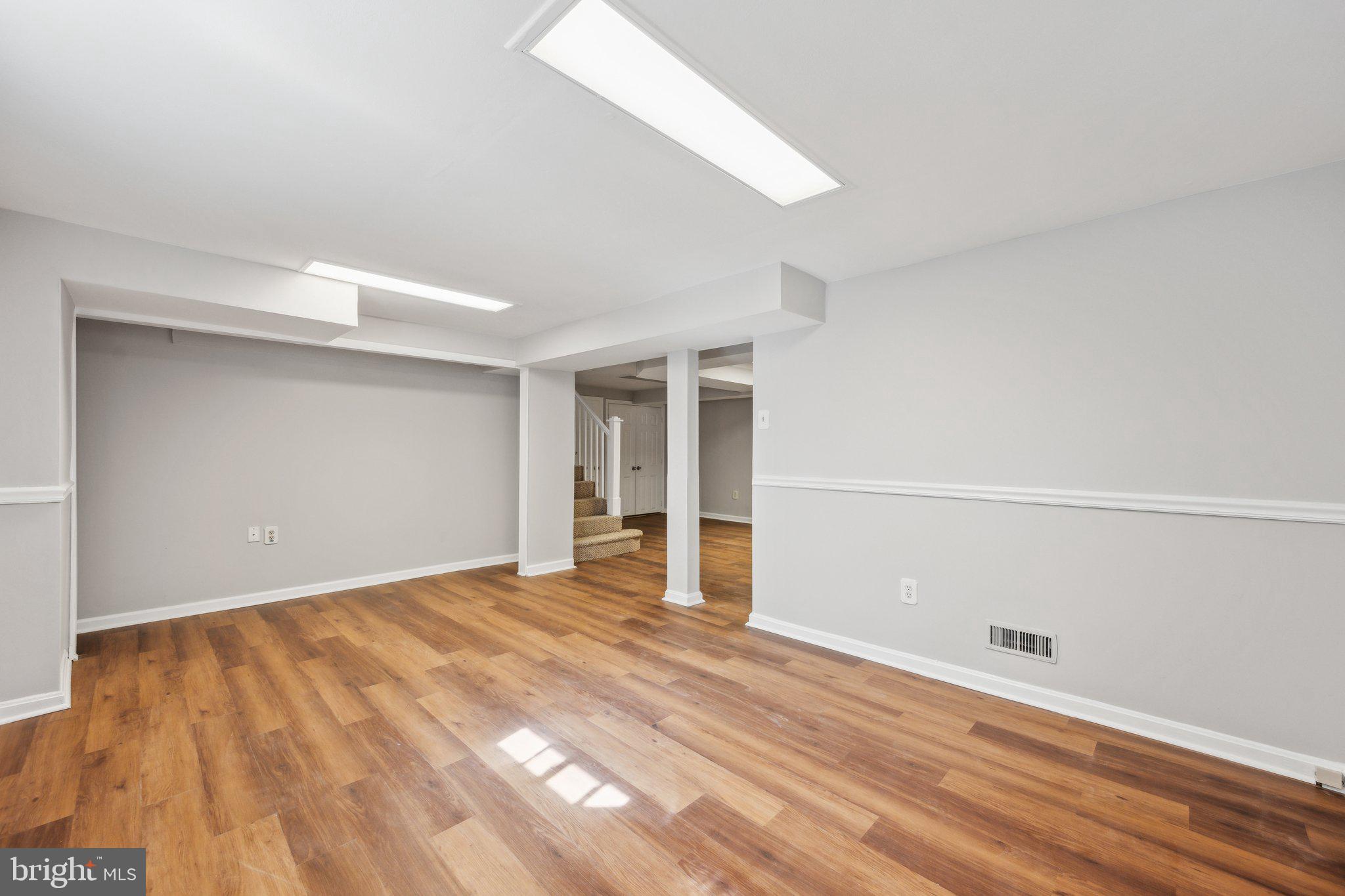 1720 Dublin Drive Silver Spring, MD 20902 - Photo 27 of 34 a view of an empty room with wooden floor