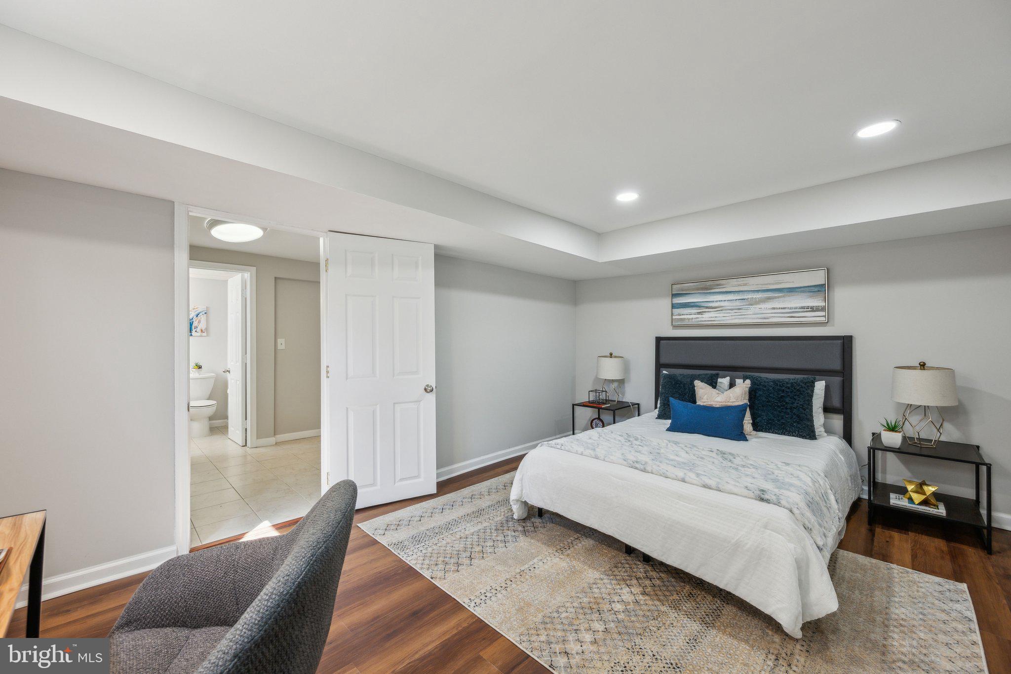 1720 Dublin Drive Silver Spring, MD 20902 - Photo 28 of 34 a bedroom with a large bed and a couch