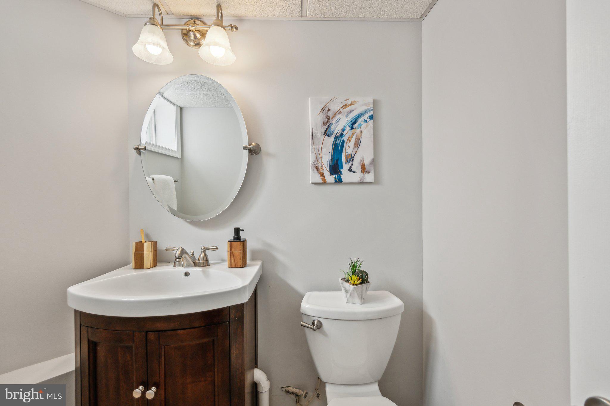 1720 Dublin Drive Silver Spring, MD 20902 - Photo 30 of 34 a bathroom with a toilet a sink and mirror