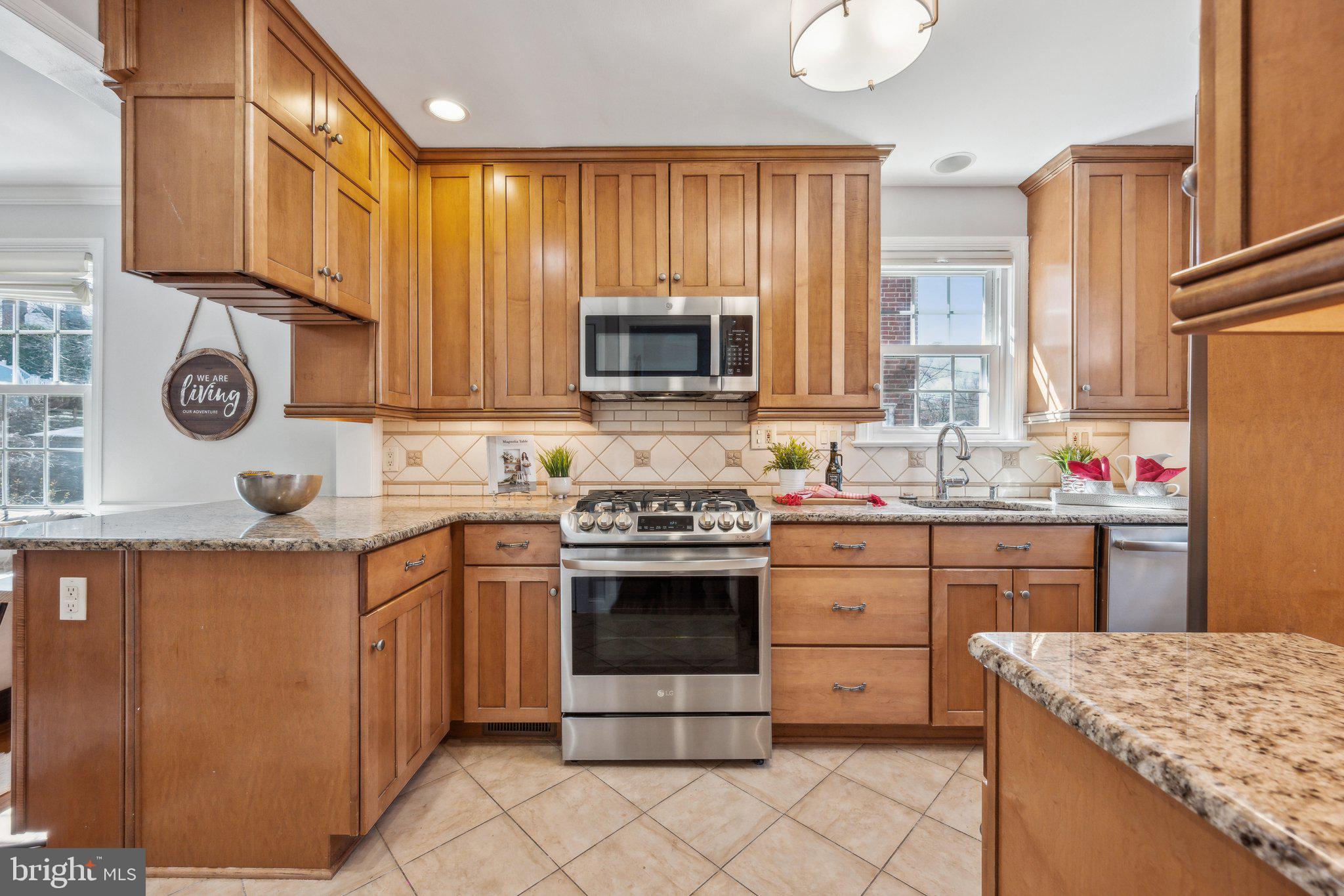 1720 Dublin Drive Silver Spring, MD 20902 - Photo 7 of 34 a kitchen with granite countertop cabinets stainless steel appliances and a sink