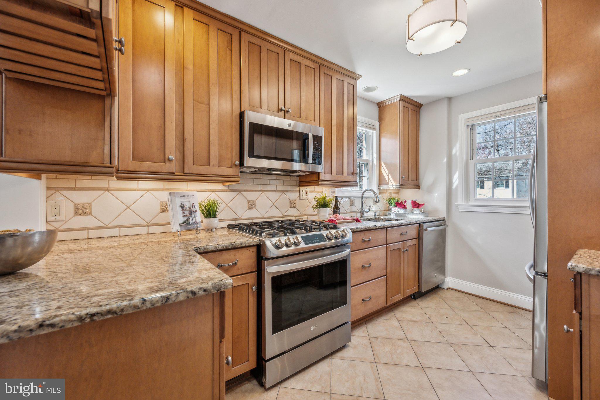 1720 Dublin Drive Silver Spring, MD 20902 - Photo 8 of 34 a kitchen with granite countertop a stove sink and microwave