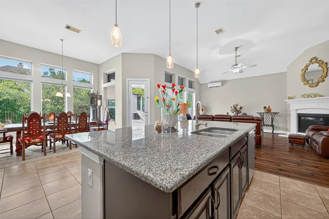 a kitchen with a stove a kitchen island a stove and a wooden floors