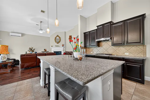 a kitchen with stainless steel appliances granite countertop a sink refrigerator and microwave