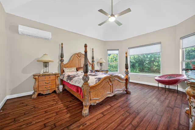 a bedroom with a bed and wooden floor
