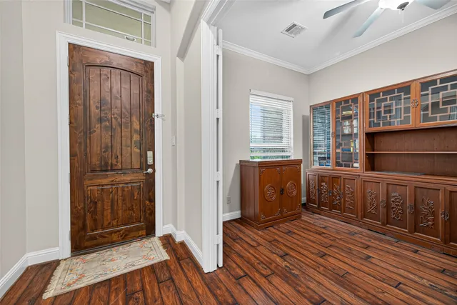 a view of wooden floor and windows in a room