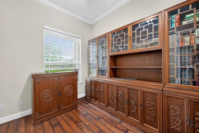 a view of a dining room with furniture wooden floor and a potted plant