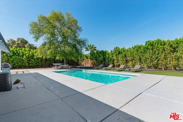 a view of a patio with table and chairs and potted plants with wooden floor