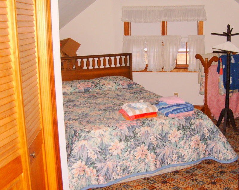 136 Scudder Road Osterville, MA 02655 - Photo 11 of 14 a bedroom with a bed and a painting on the wall