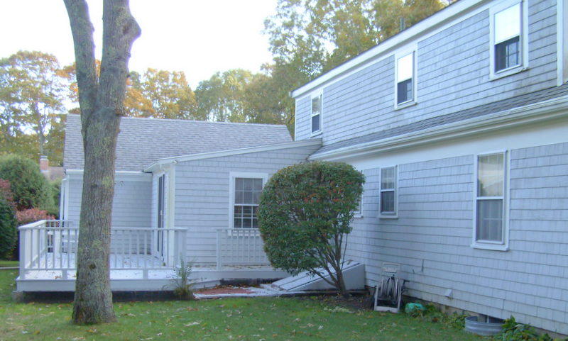 136 Scudder Road Osterville, MA 02655 - Photo 3 of 14 a view of backyard with a house and a large tree