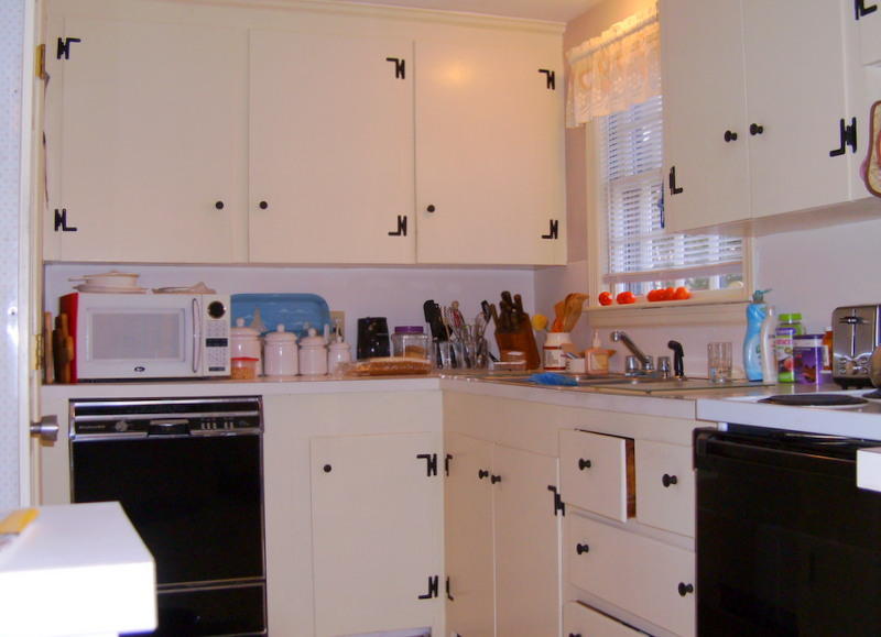 136 Scudder Road Osterville, MA 02655 - Photo 8 of 14 a kitchen with stainless steel appliances a stove a sink and white cabinets