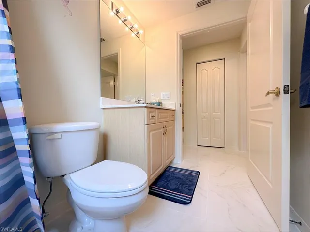 a white toilet sitting next to a bathroom sink