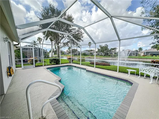 a view of a swimming pool with a patio and a yard