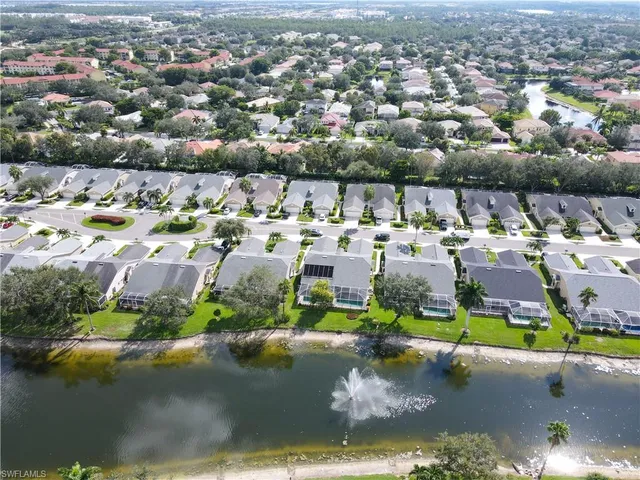 an aerial view of a houses with a lake view