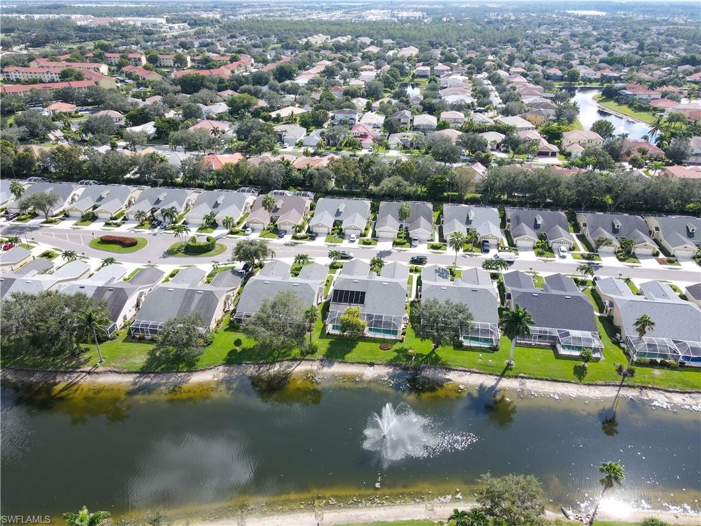 8220 Ibis Cove Circle, Unit B216 Naples, FL 34119 - Photo 17 of 34 an aerial view of a houses with a lake view