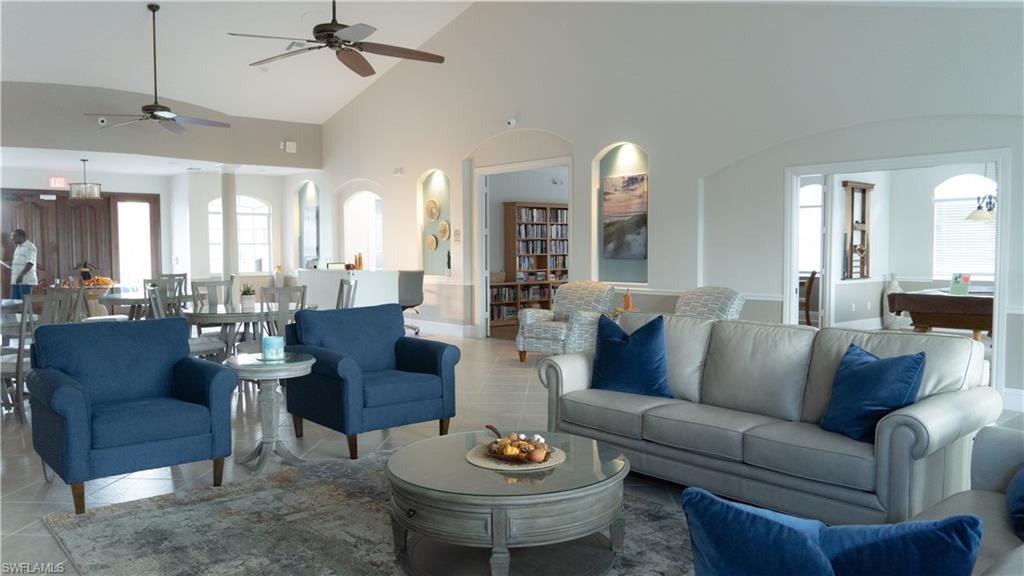 8220 Ibis Cove Circle, Unit B216 Naples, FL 34119 - Photo 19 of 34 a living room with furniture and a large mirror