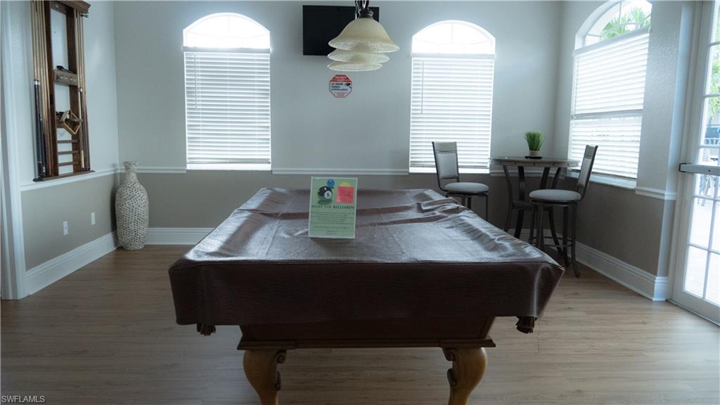 8220 Ibis Cove Circle, Unit B216 Naples, FL 34119 - Photo 20 of 34 a living room with furniture and windows