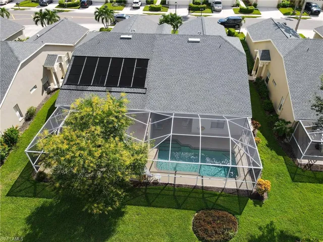an aerial view of a house with a yard and potted plants