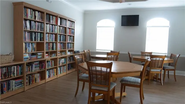 a view of a dining room with furniture and a book shelf