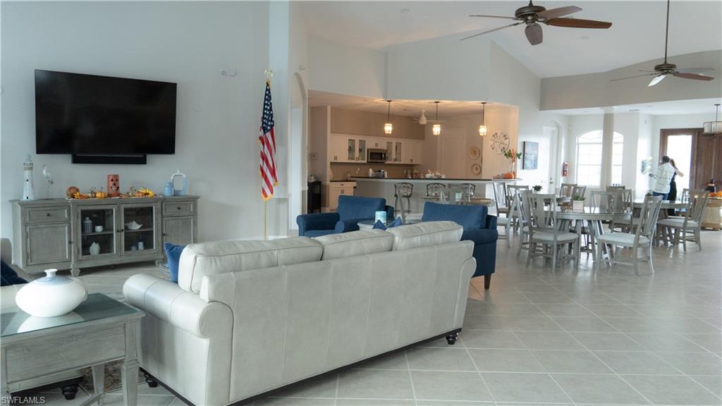8220 Ibis Cove Circle, Unit B216 Naples, FL 34119 - Photo 22 of 34 a living room with furniture and a flat screen tv