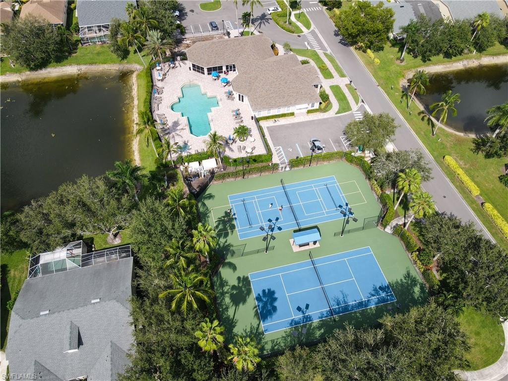 8220 Ibis Cove Circle, Unit B216 Naples, FL 34119 - Photo 24 of 34 an aerial view of a house with a yard and a large pool